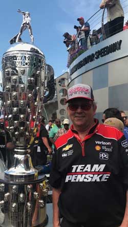 Team Penske's David Little next to the Borg Warner Trophy at the Indianapolis 500